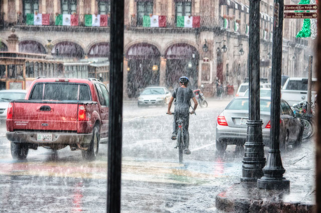 image of biking through town in the rain
