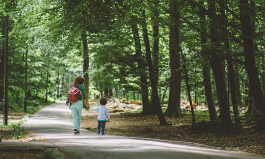 parent and child walking in the park