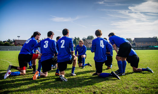 a soccer team kneeling
